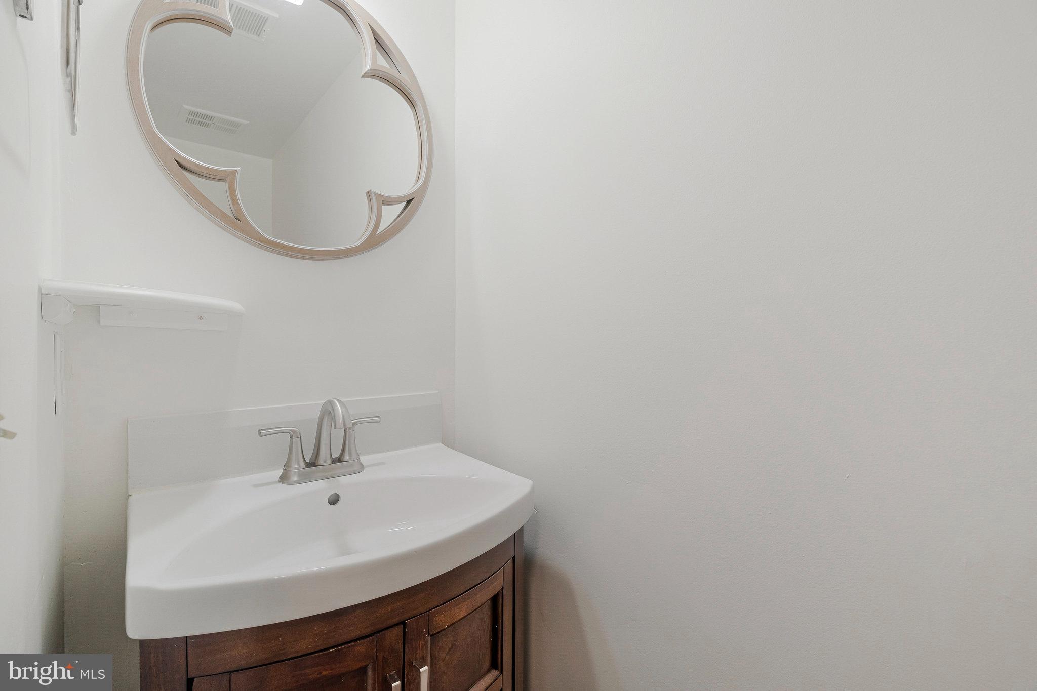 22303 Mayfield Square Sterling, VA 20164 - Photo 6 of 24 a bathroom with a sink and a mirror