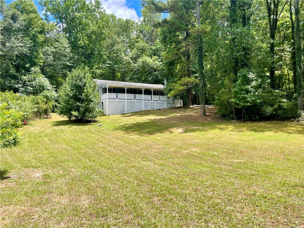 93 Laird Road Hiram, GA 30141 - Photo 1 of 1 a view of a swimming pool with an outdoor space and seating area