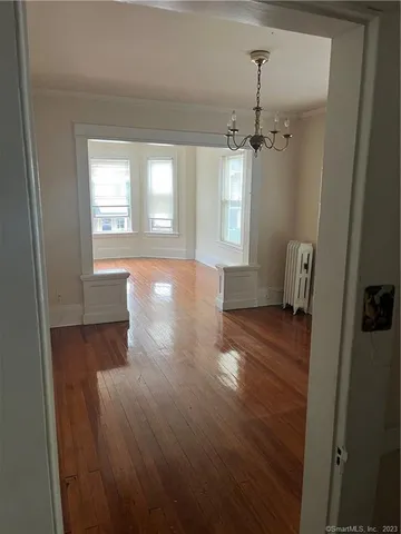 a view of a room with wooden floors and cabinet