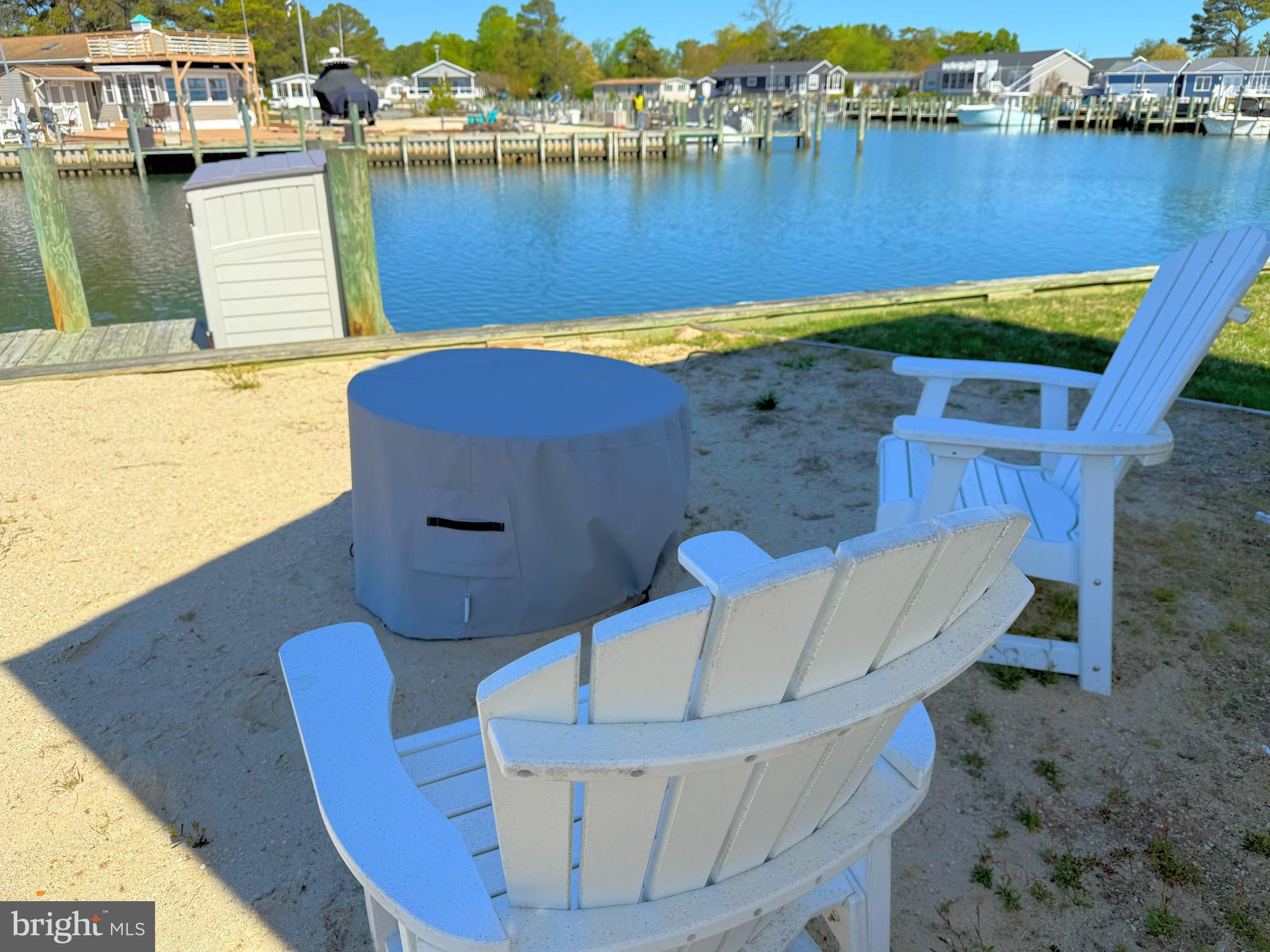 37219 Sandpiper Road, Unit 47 Long Neck, DE 19966 - Photo 14 of 62 fire pit and chairs by the water