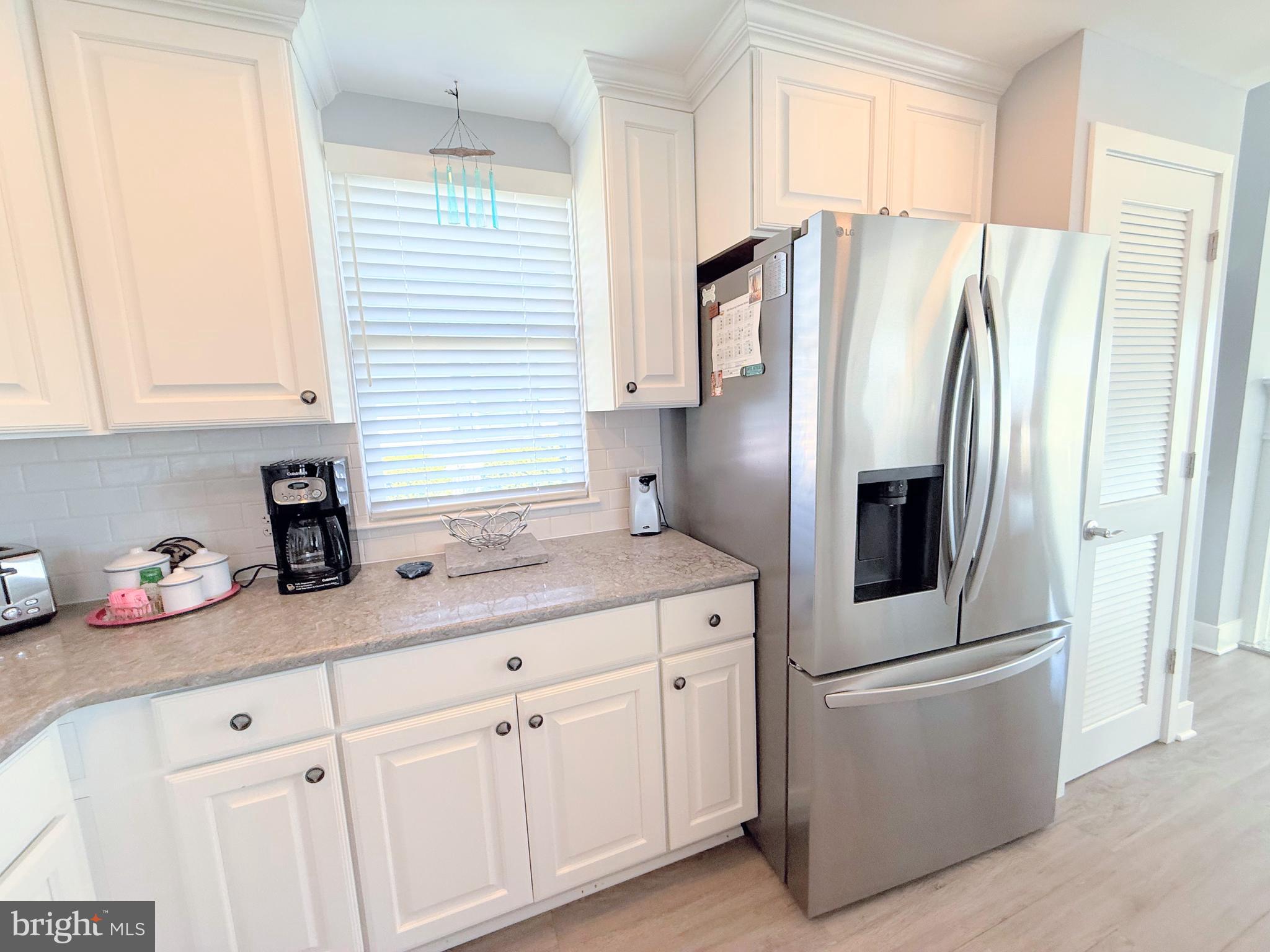 37219 Sandpiper Road, Unit 47 Long Neck, DE 19966 - Photo 27 of 62 a kitchen with stainless steel appliances a refrigerator sink and cabinets