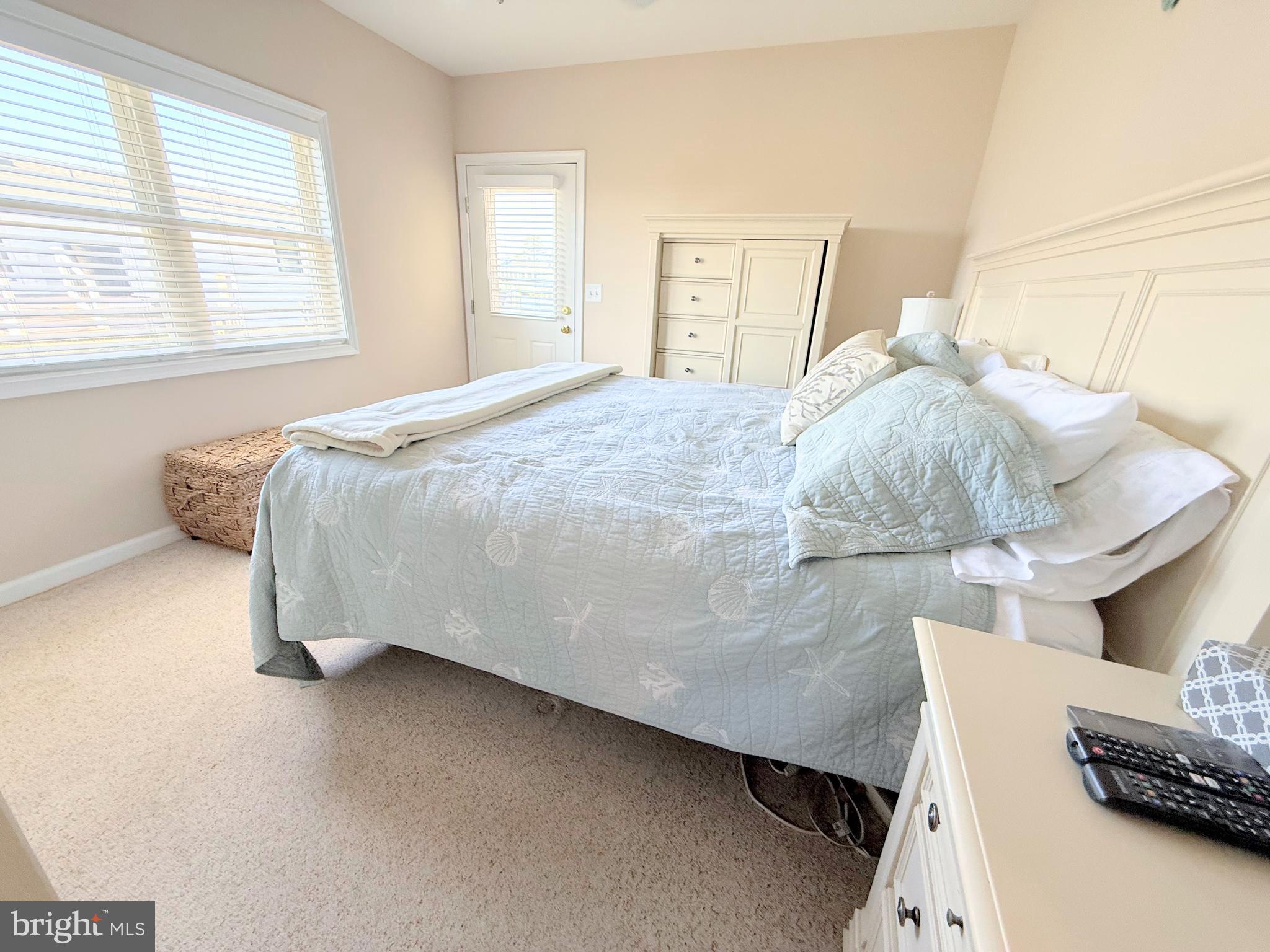 37219 Sandpiper Road, Unit 47 Long Neck, DE 19966 - Photo 31 of 62 a bedroom with a bed and a night stand