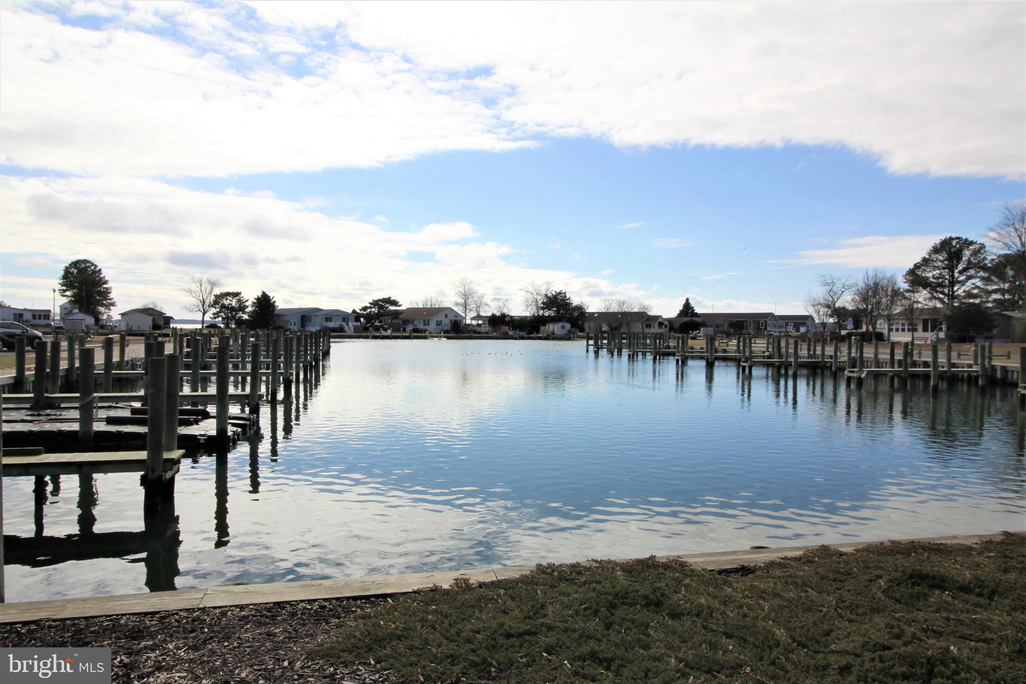 37219 Sandpiper Road, Unit 47 Long Neck, DE 19966 - Photo 53 of 62 a view of a lake with houses in the back