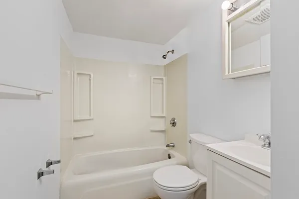 a bathroom with a toilet a sink and bathtub