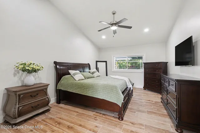 a bedroom with a bed and a television