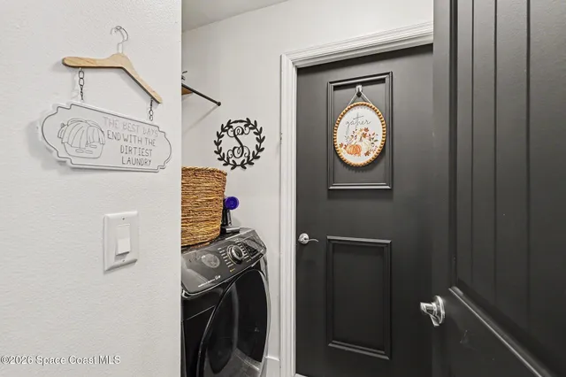 a living room with furniture a ceiling fan and a large window