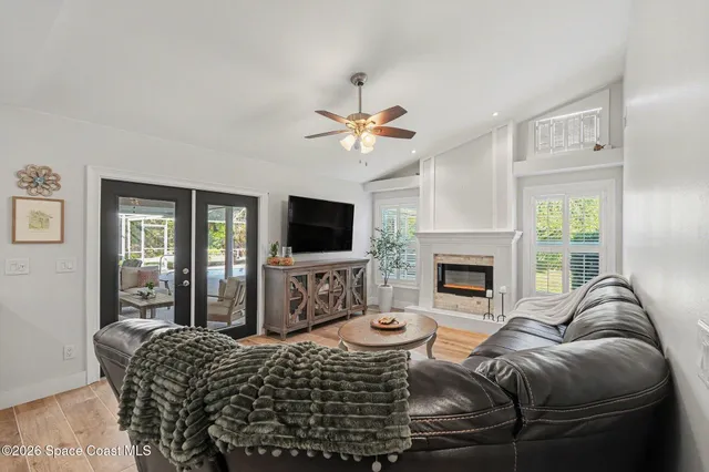 a living room with furniture a fireplace and a flat screen tv