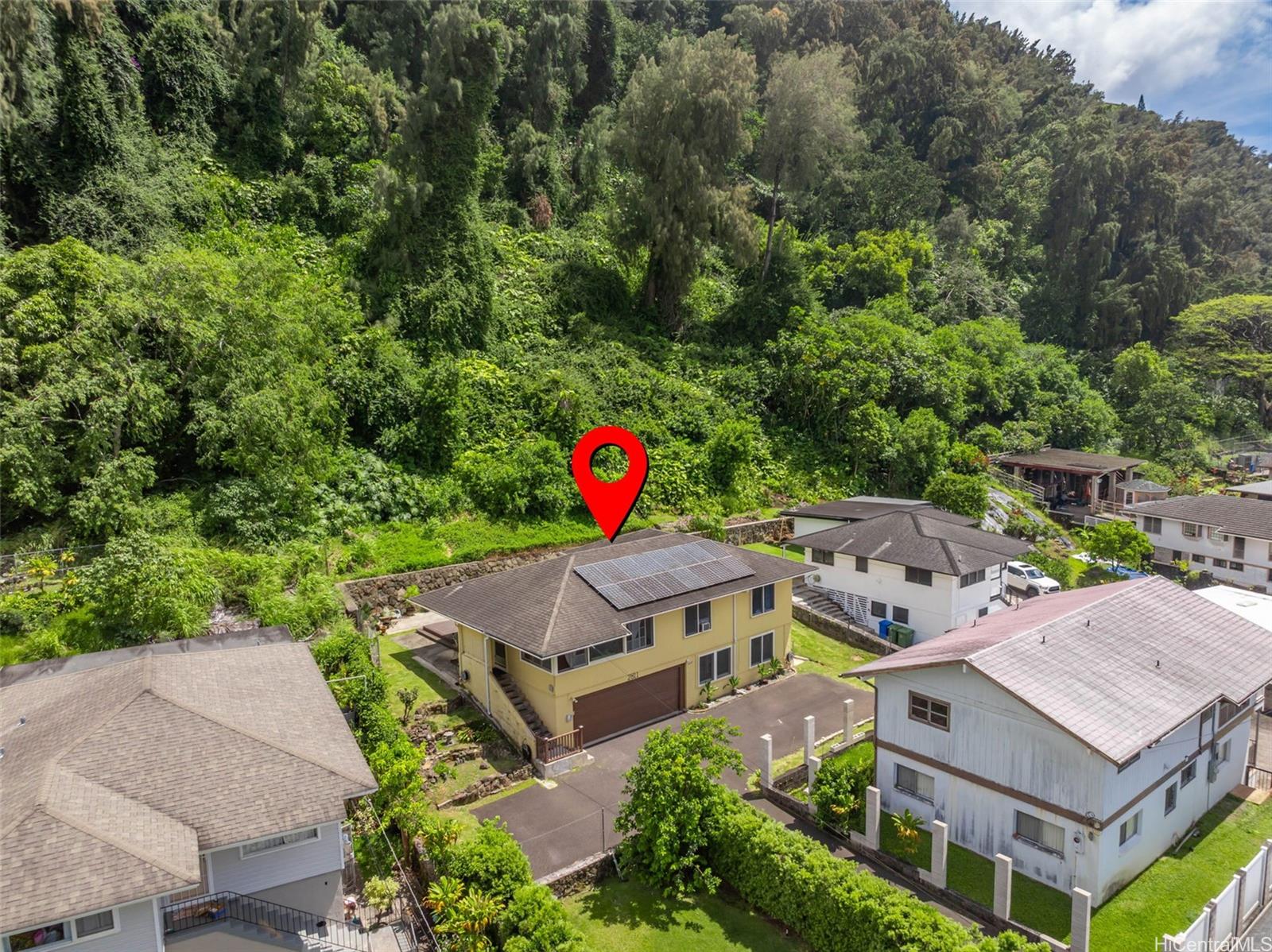 2811 Henry Street Honolulu, HI 96817 - Photo 23 of 25 An impressive aerial perspective showcases the home's fantastic roofline equipped with energy-efficient solar panels, beautifully embraced by the lush tropical hillside.