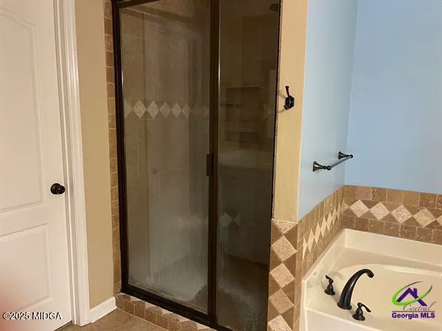 a bathroom with a bathtub and shower
