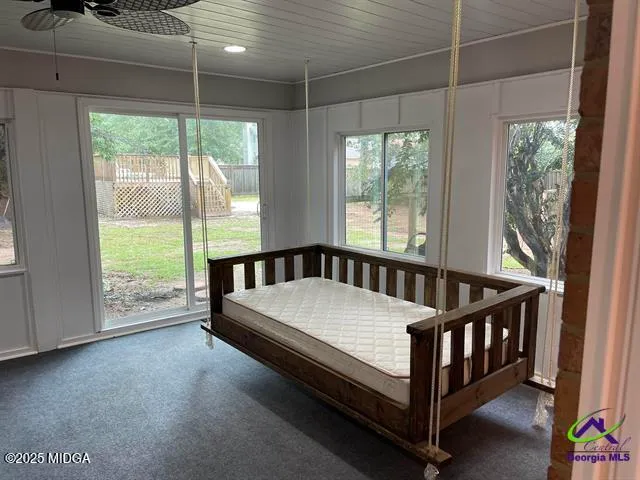 a bed sitting in a bedroom next to a window
