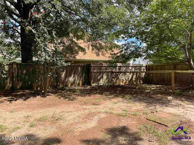 a view of a house with large trees