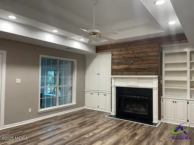 a view of a livingroom with a fireplace garage and windows