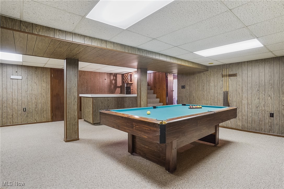 667 North Road Southeast Warren, OH 44484 - Photo 28 of 50 Recreation room with wooden walls, billiards, light colored carpet, and a drop ceiling