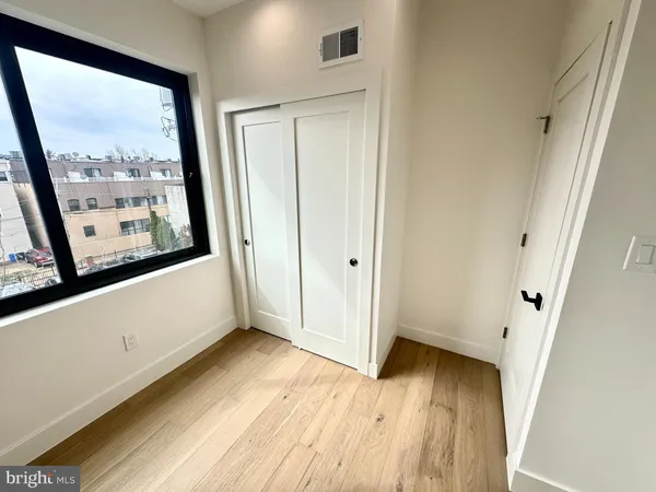 a view of front door with wooden floor