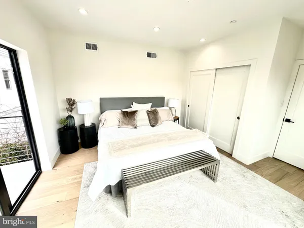 a bedroom with a bed and a large mirror