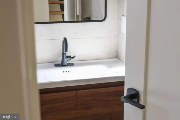 a close view of a sink and a mirror in the window