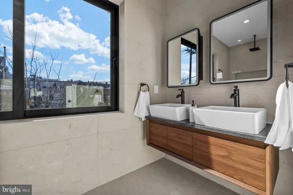 a bathroom with a bathtub and mirror