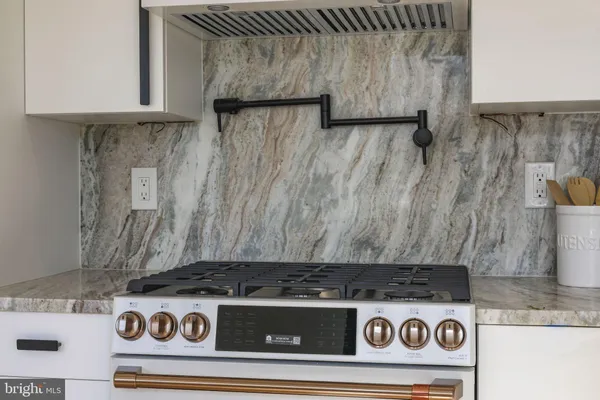a stove top oven sitting inside of a kitchen
