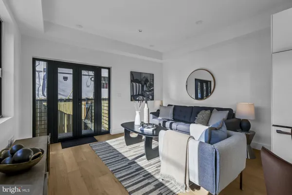 a living room with furniture and a floor to ceiling window