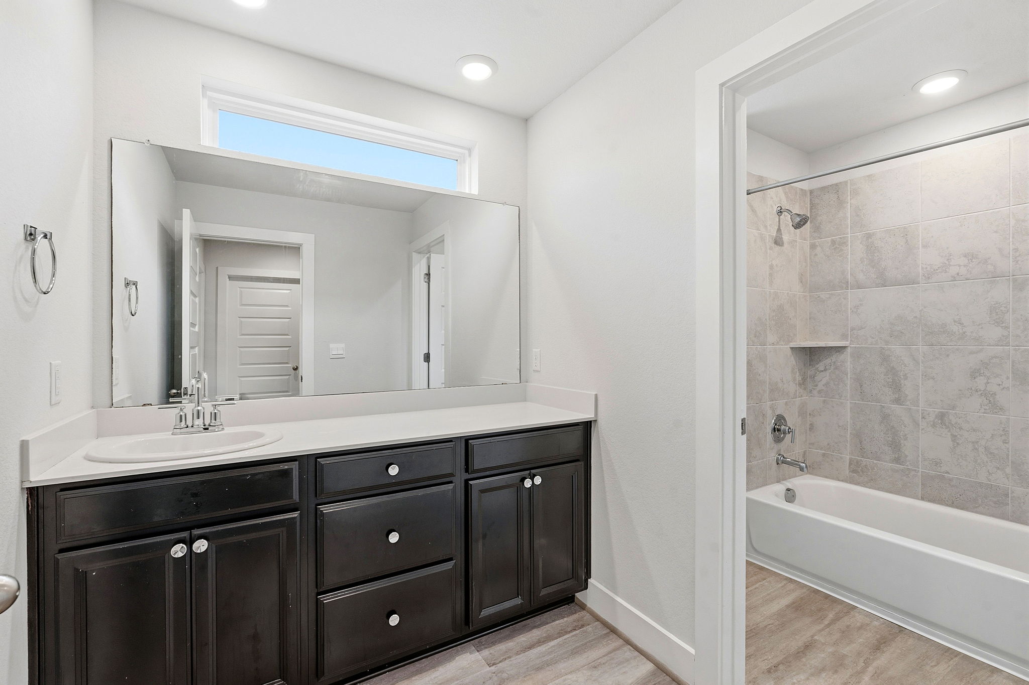 7105 Silver Star Lane, Unit 59 Austin, TX 78744 - Photo 14 of 19 a bathroom with a tub a sink double vanity and a mirror