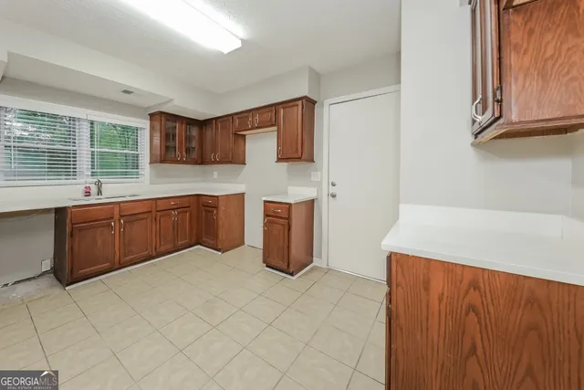 a kitchen with stainless steel appliances a sink and a refrigerator