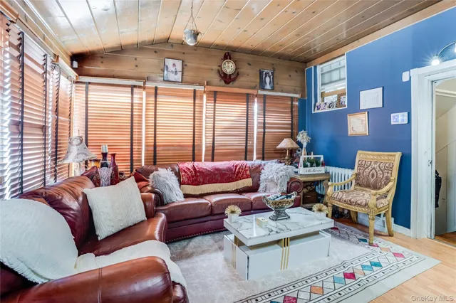 a room with furniture a flat screen tv and a chandelier