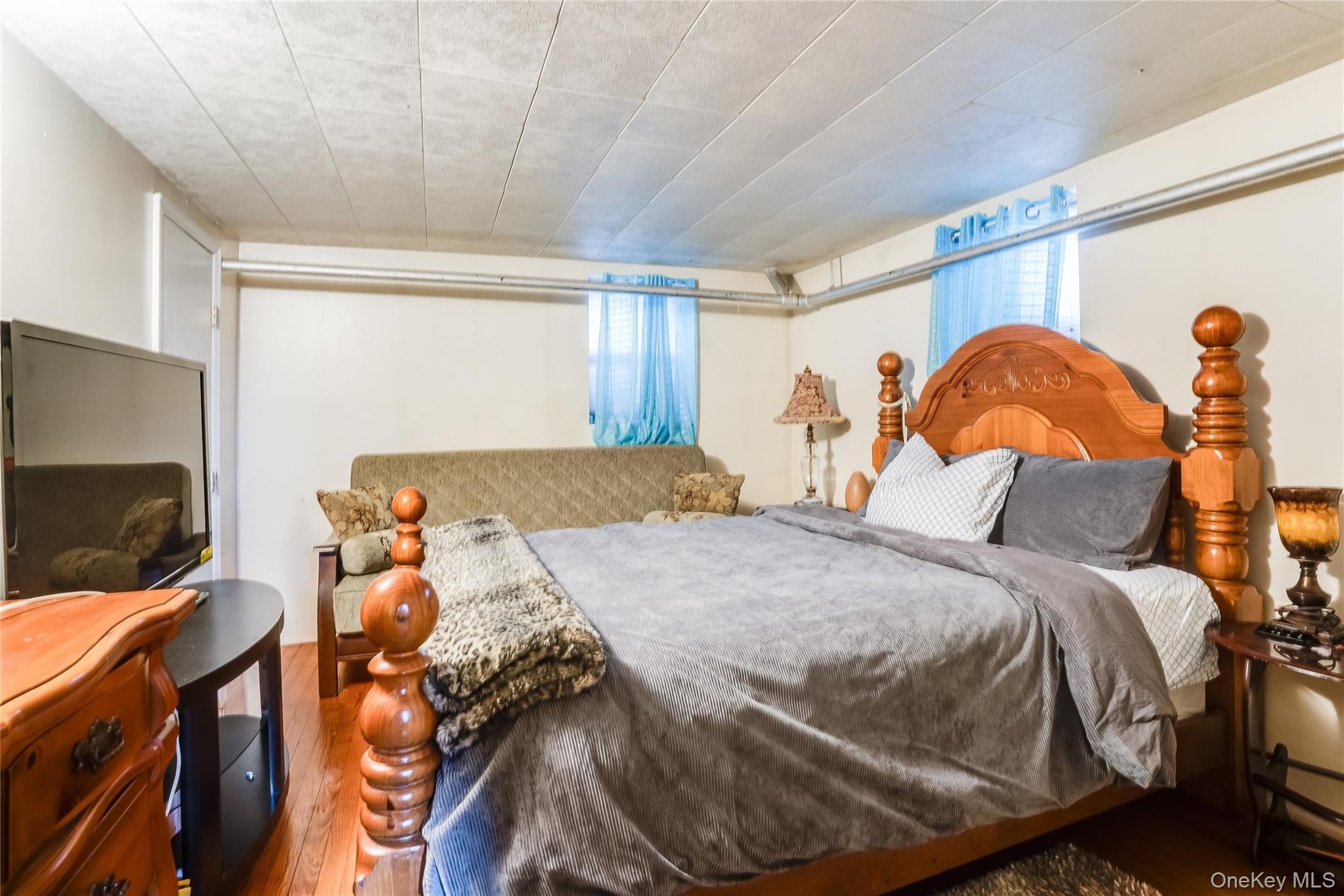 122 Hamilton Road Hempstead, NY 11550 - Photo 13 of 20 Bedroom featuring wood finished floors and multiple windows