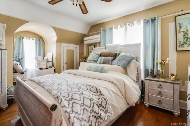 a bed sitting in a bedroom and tv