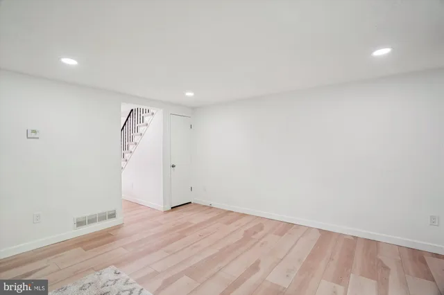 an empty room with wooden floor