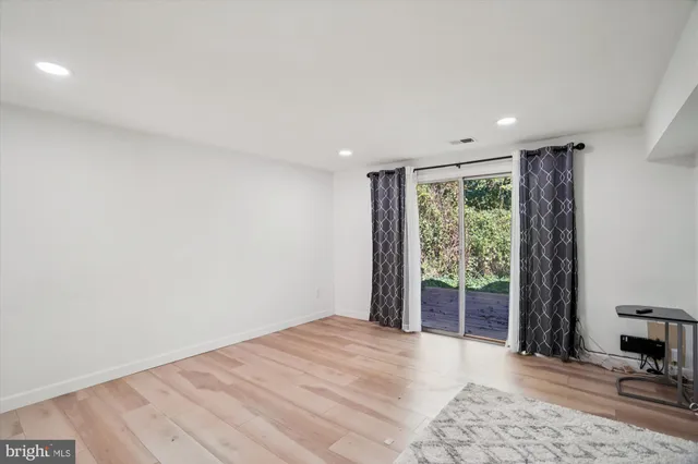 a big room with wooden floor and windows