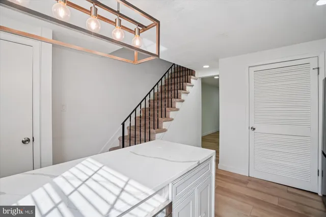 a view of a hallway with wooden floor and staircase