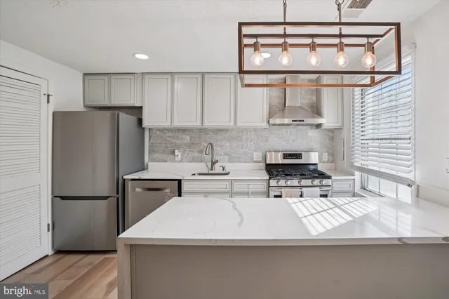 a kitchen with a sink a refrigerator and window