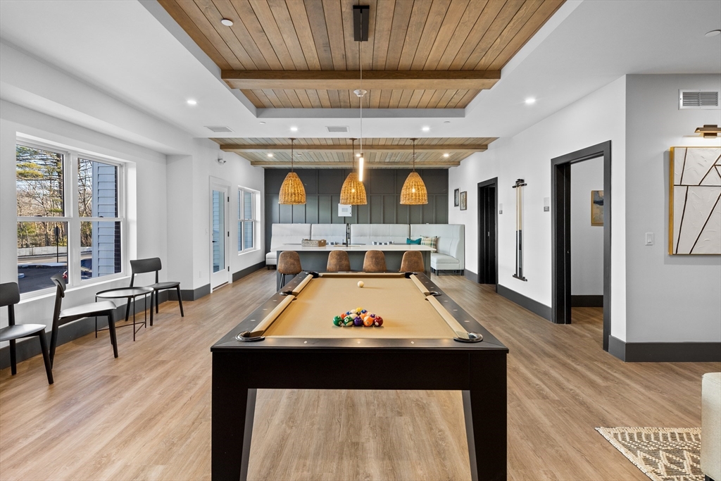 635 Main Street, Unit 209 Wilmington, MA 01887 - Photo 15 of 18 a room with furniture pool table wooden floor and windows