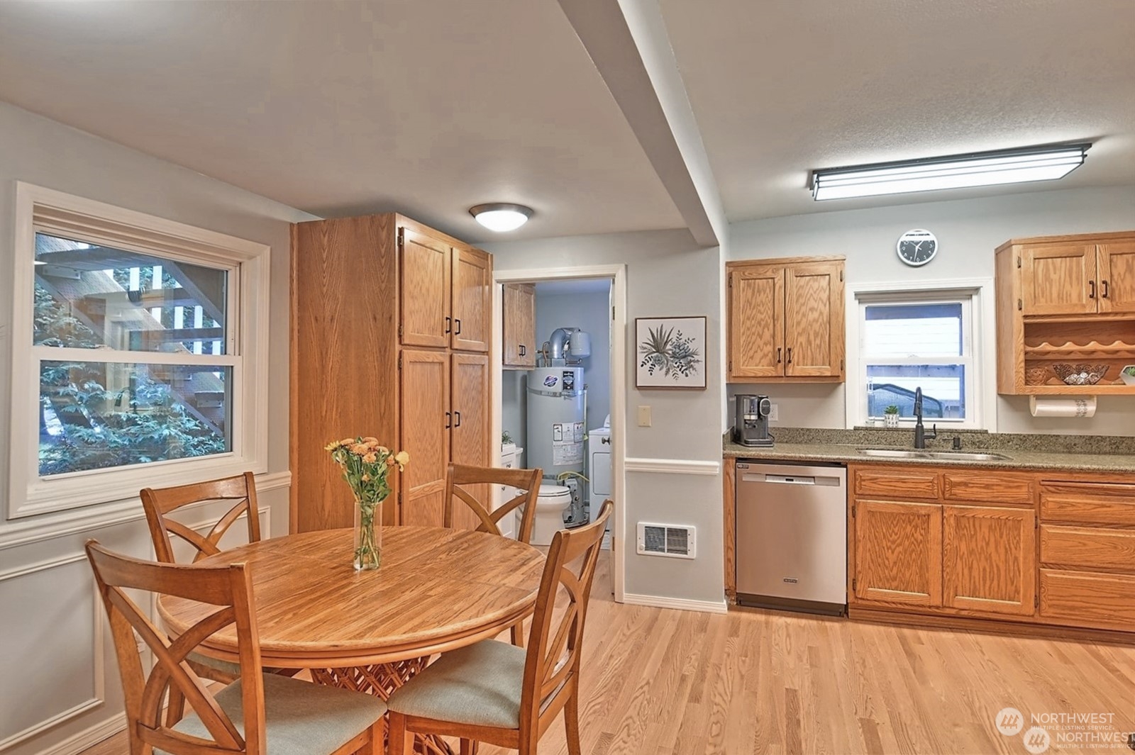 11019 Uct Loop Road Lake Stevens, WA 98258 - Photo 19 of 38 a kitchen with stainless steel appliances granite countertop a stove a sink dishwasher a dining table and chairs with wooden floor