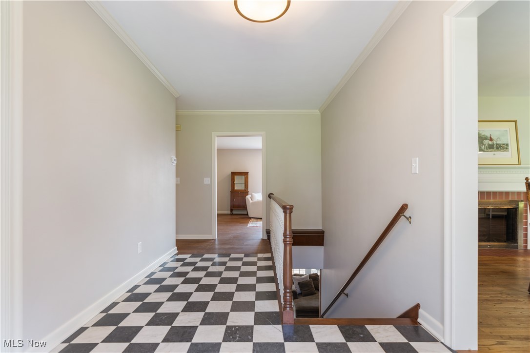 2622 Glenmont Road Northwest Canton, OH 44708 - Photo 6 of 45 Hallway with dark floors, baseboards, an upstairs landing, and ornamental molding