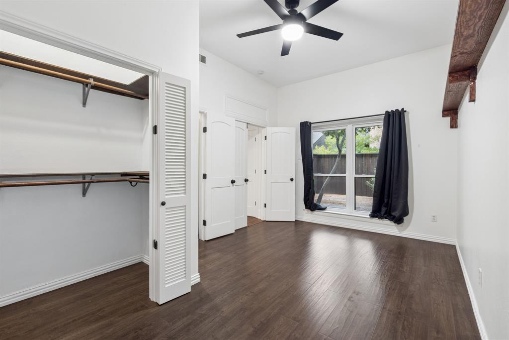 15539 Preston Road, Unit 1037 Dallas, TX 75248 - Photo 14 of 36 Vaulted ceilings, wood-finish flooring, a ceiling fan, louvered closet doors, and an arched interior door