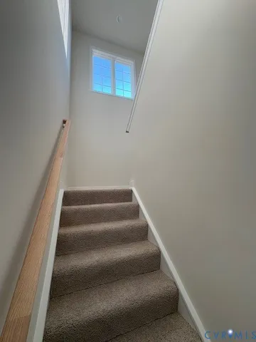 a kitchen with stainless steel appliances granite countertop white cabinets a sink and a stove