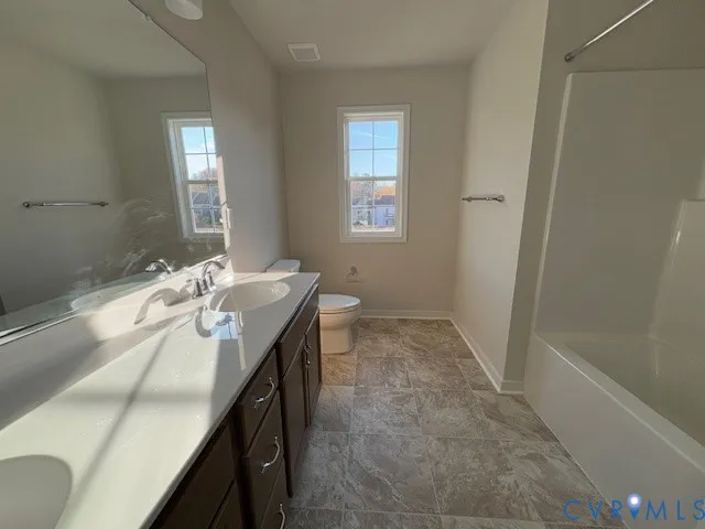 a large kitchen with stainless steel appliances granite countertop a stove a sink and a refrigerator