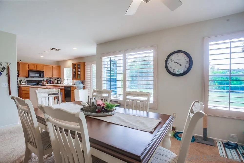 498 Shadow Tree Drive Oceanside, CA 92058 - Photo 11 of 42 a dining room with furniture and window