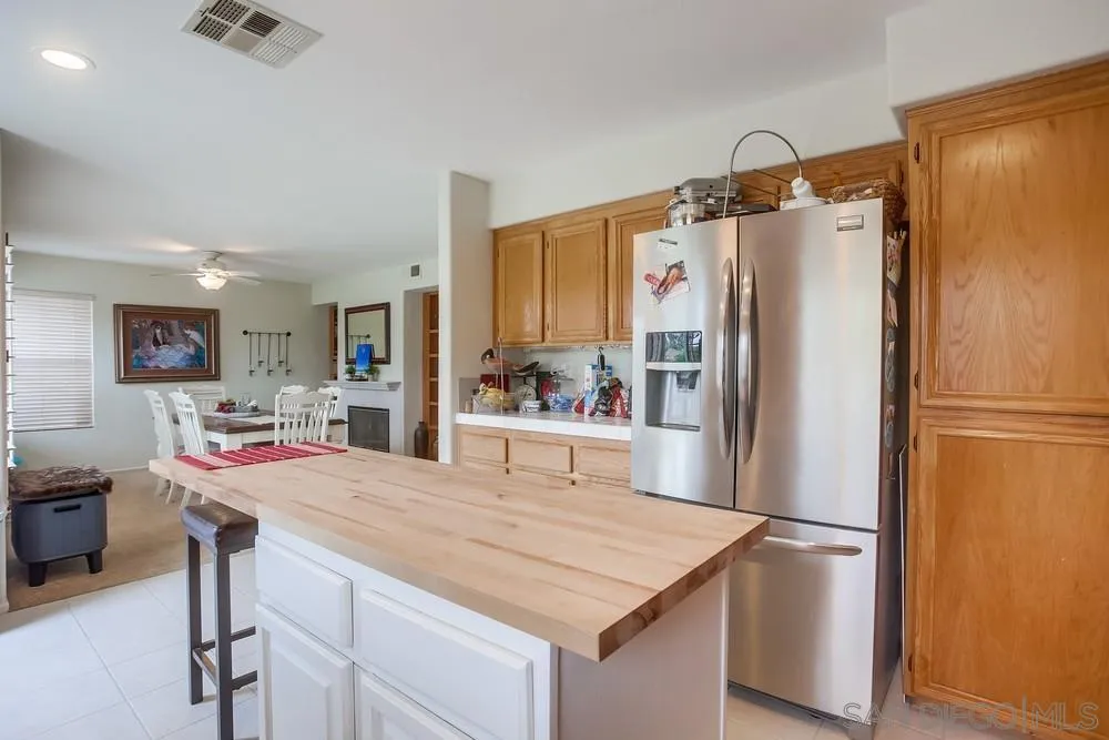 498 Shadow Tree Drive Oceanside, CA 92058 - Photo 16 of 42 a kitchen with stainless steel appliances a refrigerator and a stove