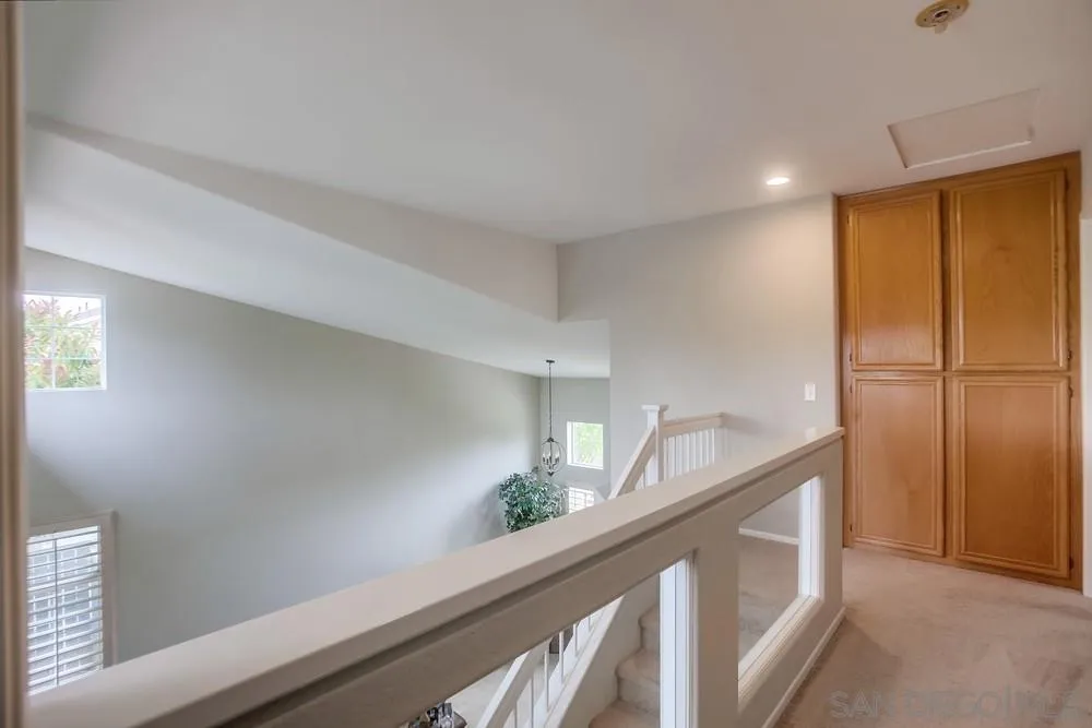 498 Shadow Tree Drive Oceanside, CA 92058 - Photo 20 of 42 a hallway with sink and wooden floor