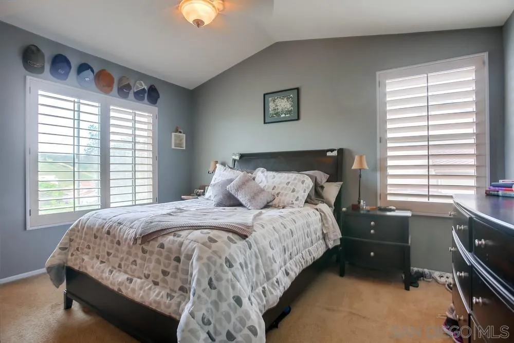 498 Shadow Tree Drive Oceanside, CA 92058 - Photo 23 of 42 a bed sitting in a bedroom next to a window