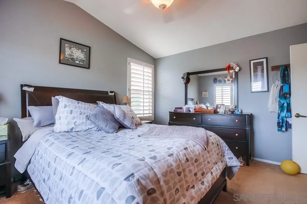 498 Shadow Tree Drive Oceanside, CA 92058 - Photo 25 of 42 a bedroom with a bed and window