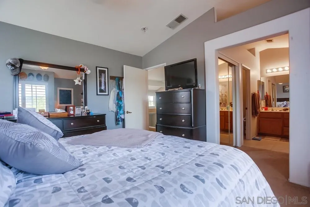 498 Shadow Tree Drive Oceanside, CA 92058 - Photo 26 of 42 a bedroom with a bed and a television in it