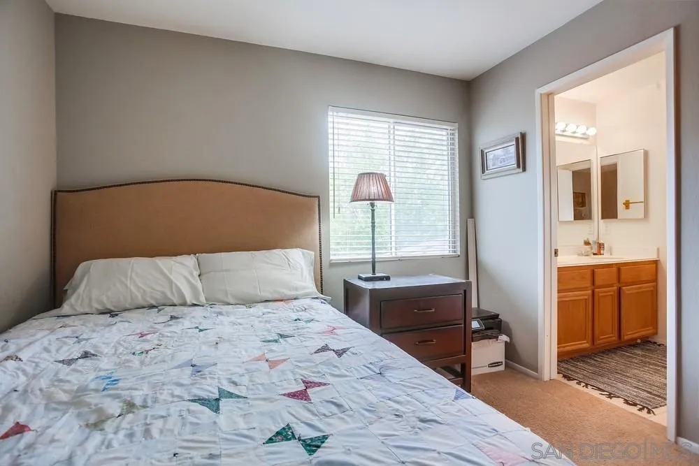 498 Shadow Tree Drive Oceanside, CA 92058 - Photo 32 of 42 a bedroom with a large bed and a dresser