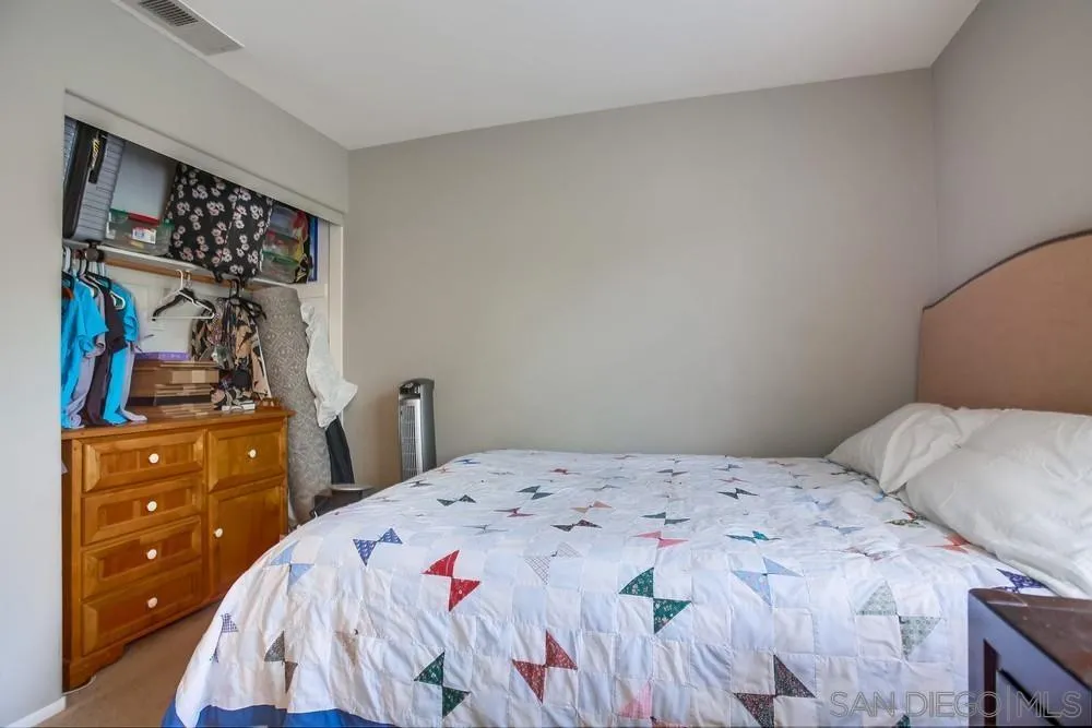 498 Shadow Tree Drive Oceanside, CA 92058 - Photo 33 of 42 a bedroom with a bed and a closet