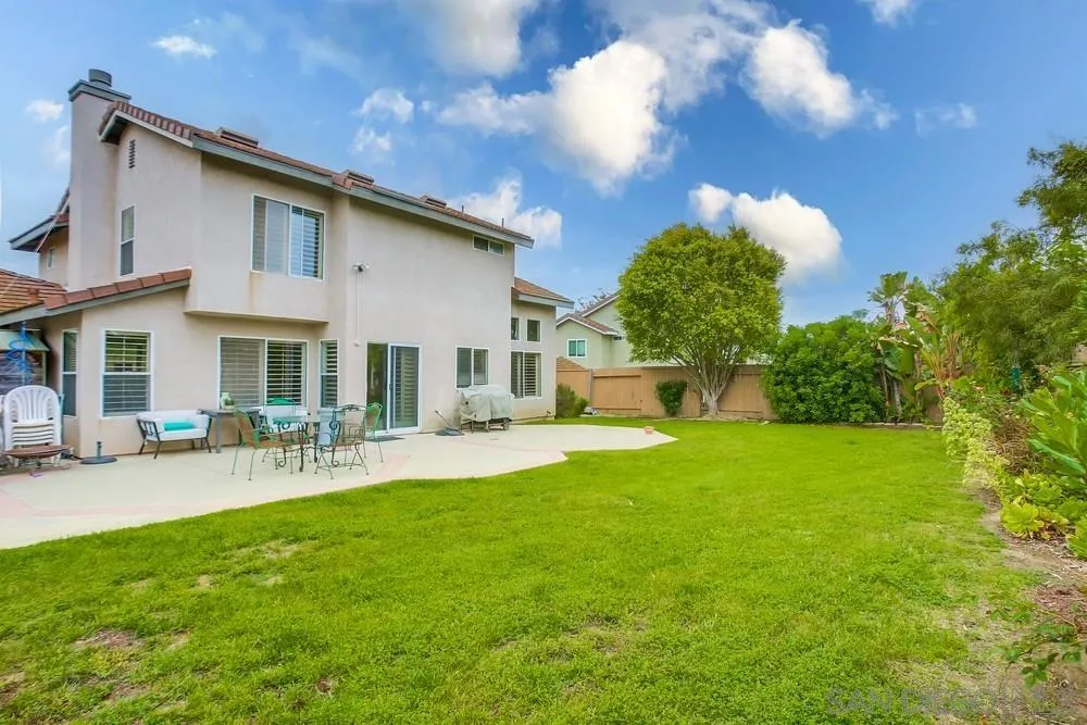 498 Shadow Tree Drive Oceanside, CA 92058 - Photo 38 of 42 a backyard of a house with table and chairs