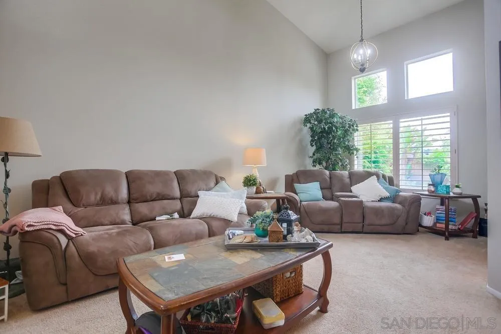 498 Shadow Tree Drive Oceanside, CA 92058 - Photo 7 of 42 a living room with furniture and a large window
