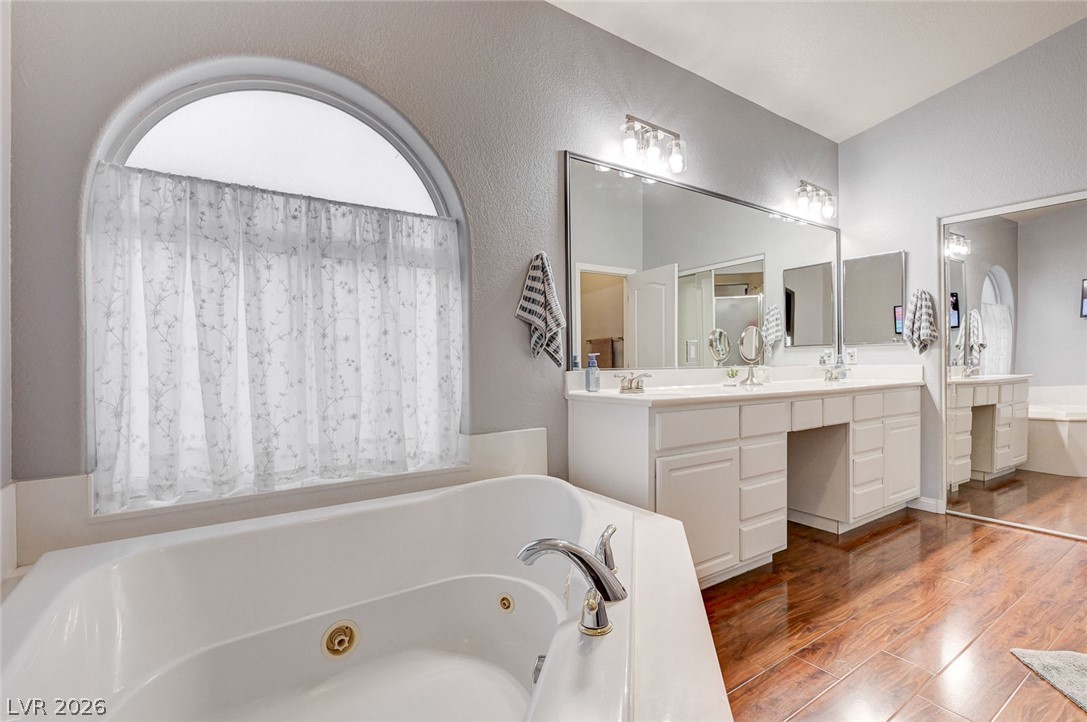 1604 Cattle Ranch Place Henderson, NV 89002 - Photo 39 of 99 Indulge in a tranquil retreat featuring a spacious soaking tub and dual vanities, perfect for unwinding.