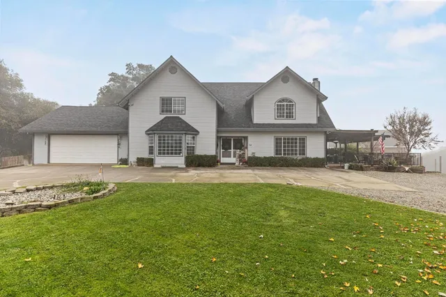 a front view of a house with a garden and yard